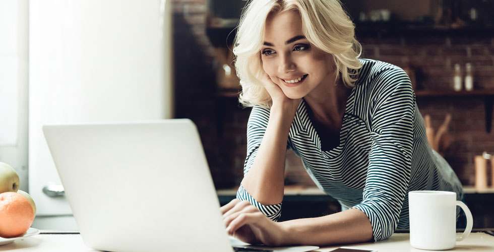 Blond_Woman_Looking_at_Laptop